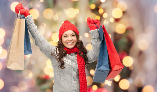 happy woman in winter clothes with shopping bags