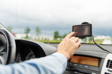 close up of man with gps navigator driving car