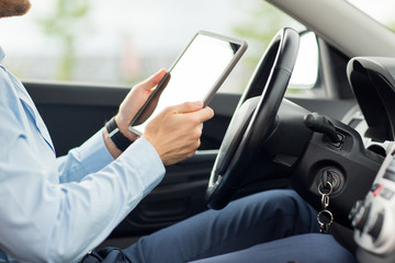 close up of young man with tablet pc driving car