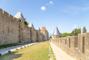 Fototapeta na wymiar Carcassonne, France. The road to the site of the moat between the two rows of walls. Fortress of Carcassonne is included in the UNESCO World Heritage List