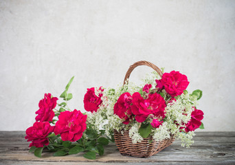 Fototapeta na wymiar flowers in basket on old background