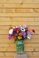 Flowers and wooden wall