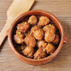 spanish meatballs stew on a wooden rustic table