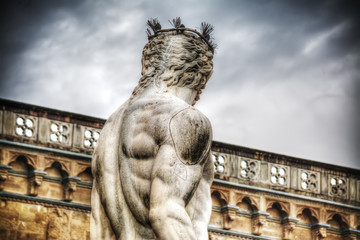 back view of Neptune statue in Piazza della Signoria in Florence