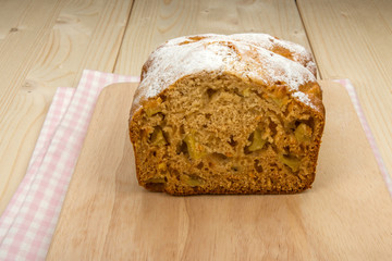 Fruit cake on a linen napkin and a light wooden board