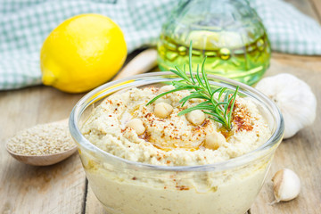Bowl of classic hummus sprinkled with paprika and sesame
