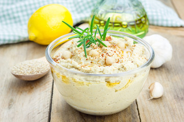 Bowl of classic hummus sprinkled with paprika and sesame