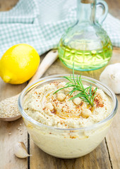 Bowl of classic hummus sprinkled with paprika and sesame