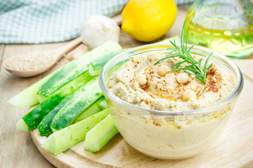Bowl of classic hummus sprinkled with paprika and sesame
