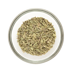 Top view of Organic Aniseed (Pimpinella anisum) half filled in glass bowl isolated on white background.