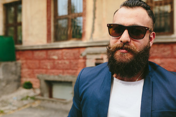 Stylish bearded man walks through the city