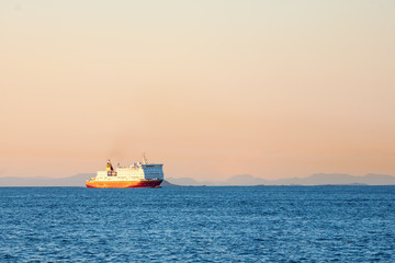 Naklejka na ściany i meble Ferry on the sea at sunset