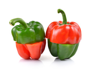 red and green pepper over white background