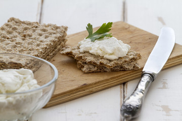 Crispbread with cheese on a vintage wooden background
