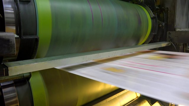 Web set offset print shop newspapers Printint, Newspapers coming off the rotation printing press industrial machine. UHD 4K steadycam stock footage