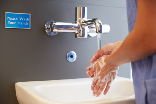 Close Up Of Medical Staff Washing Hands
