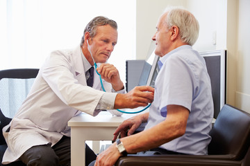 Senior Patient Having Medical Exam With Doctor In Office