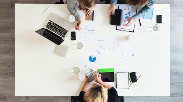 Diverse group of people aerial view timelapse creative business meeting planning thinking ahead startup company