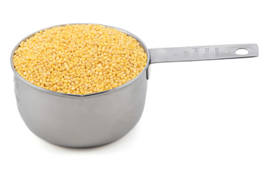 Millet grains in a measuring cup