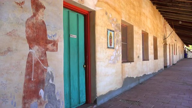 Murals line the adobe walls of a California Mission.