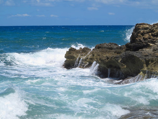 Fototapeta na wymiar Big waves on rock coast blue sea and sky on Crete