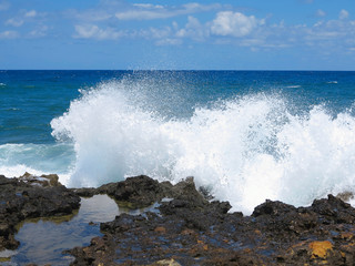 Big waves on rock coast blue sea and sky on Crete