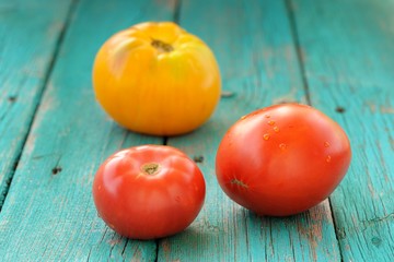 Two red one yellow tomatoes