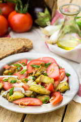 Warm autumn salad with eggplant, tomato, onion