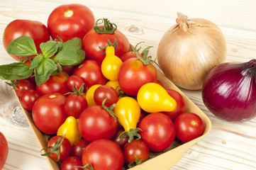 yellow and red tomatoes on wooden table