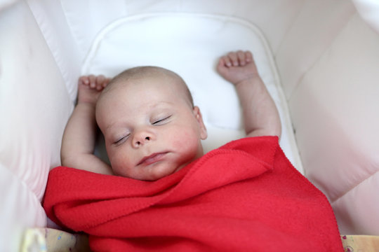 Baby Sleeping Under Red Blanket