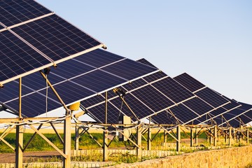 Solar panels on the background field and blue sky