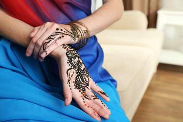 Image of henna on female hands, closeup