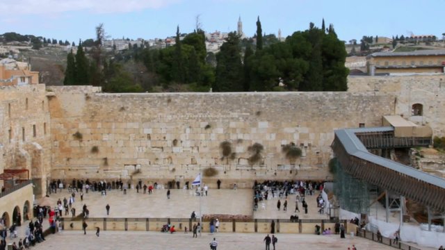 Unidentified Jewish worshipers  at the holiest Jewish site - Western wall at a typical day.  Men and Women parts of  Wailing Wall