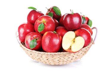Ripe red apple in wicker basket isolated on white