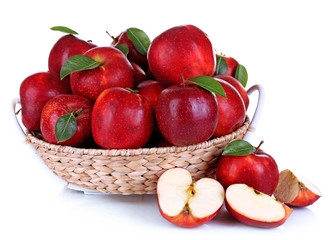 Ripe red apple in wicker basket isolated on white