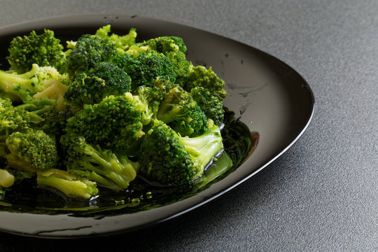 Frozen broccoli in black plate