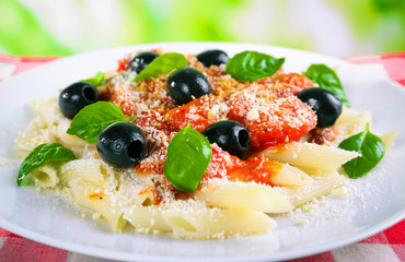 Pasta with tomato sauce on bright background