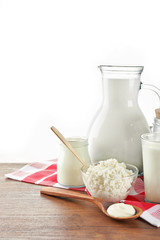 Dairy products on wooden table on white background