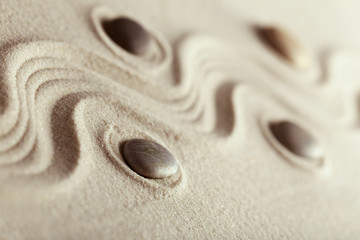 Zen garden with stones on sand background