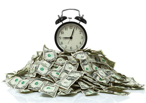 Clock on top of a pile of cash