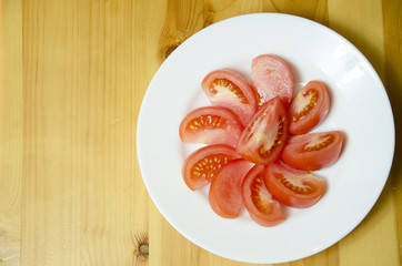 sliced tomato on a white plate