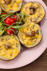 Baked potatoes with cheese and mushrooms on table close up