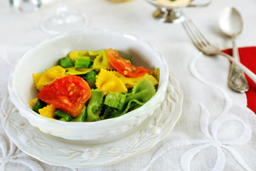 Roasted asparagus and tasty pasta with vegetables in bowl on wooden table background