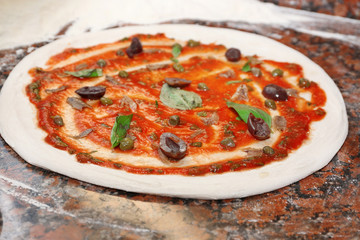 Preparing pizza on marble table, closeup