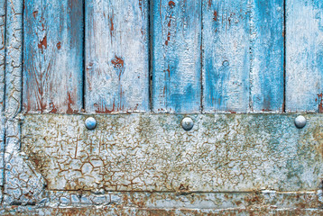 door of planks reinforced sheet of rusty metal texture background
