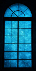 Realistic blue color heavy snowfall view through closed framed window. Lovely Christmas or New Year Holiday concept background.