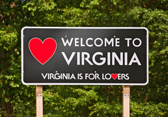 Obraz premium Virginia is for Lovers, state moto and welcome sign on a billboard sorrounded by trees