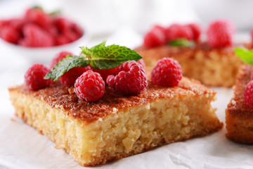Fresh pie with raspberry on parchment on wooden table, closeup