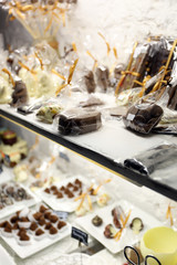 Showcase with chocolate candies close up