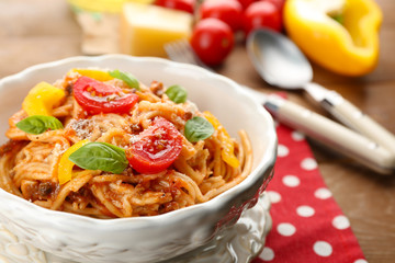 Homemade Spaghetti Bolognese with parmesan cheese in white bowl, on color wooden background